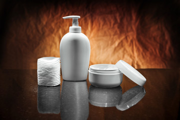 white skincare items on dark background