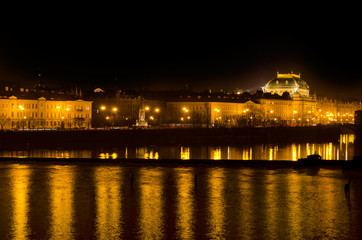 Obraz na płótnie Canvas Night lights of Prague National Theater and the Vlava river quay