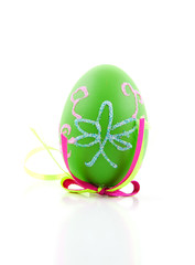green decorated easter egg over white background