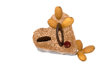 heart-shaped cake with almonds on white background
