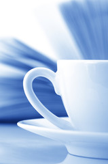 Cup of coffee and book close-up