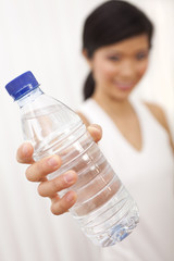 Asian Chinese Girl Holding Bottle of Pure Water to Camera