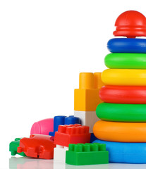 colorful plastic toys and bricks on white