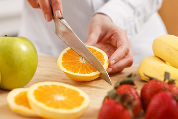 Woman cutting orange