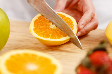 Woman cutting orange