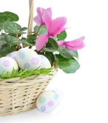 paint eggs and pink flower in basket