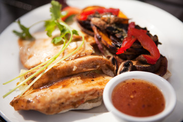 Chicken fillets on roosterkoek with vegetables