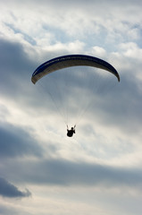 Paraglider silhouette and dramatic sky