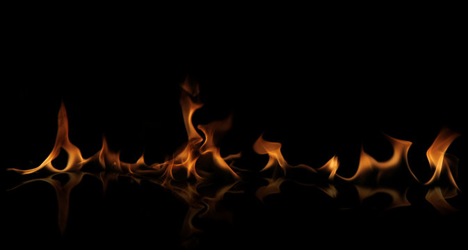 Fire wall with reflection on black background