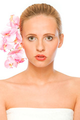 Young beautiful woman with pink orchids in her hair  isolated