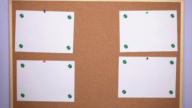 HD: a person leaves a sheet of paper on the pinboard
