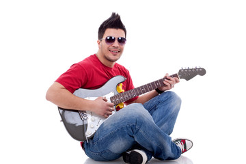 seated guitarist playing an electric guitar
