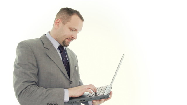 Angry businessman hitting and throw away laptop, isolated