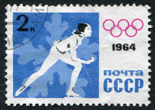 Postage stamp 1964: Man on the skates and the Olympic symbol