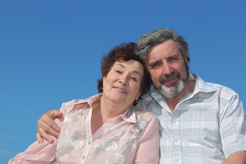 portrait of old man and woman embracing and smiling