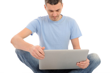 handsome young male working on laptop computer. isolated