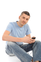 casual young man with cell phone and headphones. isolated