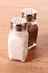 Salt and pepper shaker on wooden background