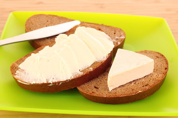 knife and a bread with butter on the plate