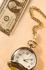 Watch and dollar isolated on papper background
