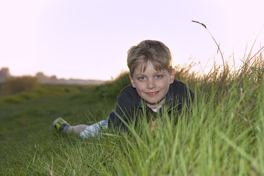 Portrait of young boy backlit against beautiful setting sun
