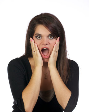 Young woman with hands holding her face in surprise