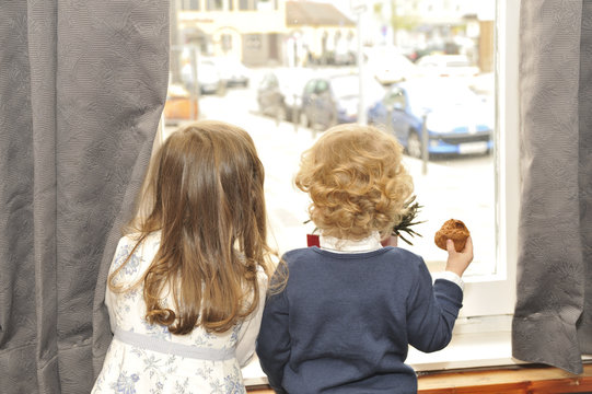 Boy and Girl Looking out the Window