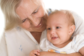 elderly woman holding a newborn