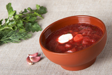 Borscht in a brown ceramic plate