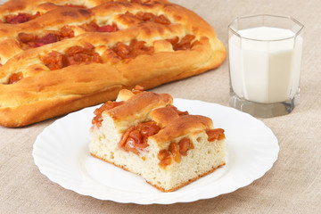 Homemade pie with apples and a glass of milk