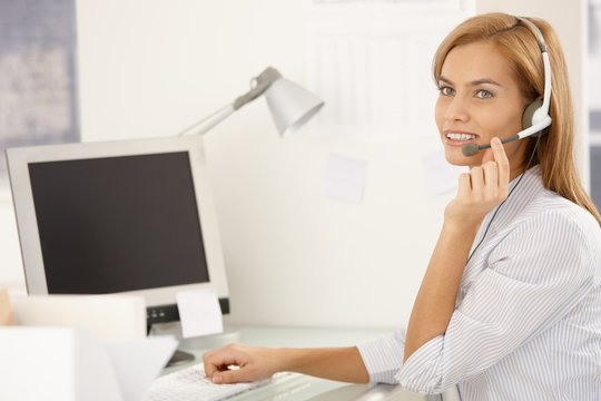 Happy call center worker girl with headset