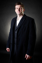 Elegant handsome young man on dark background