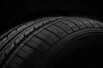 Car tire on black background