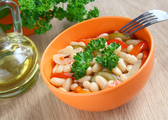A bowl of stewed beans and vegetables.