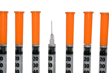 Several insulin syringe on white background