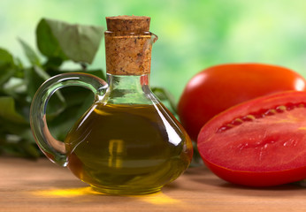 Olive oil with tomato and basil leaves