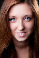 Naklejka premium Close-up face of beautiful smiling girl. Studio shot