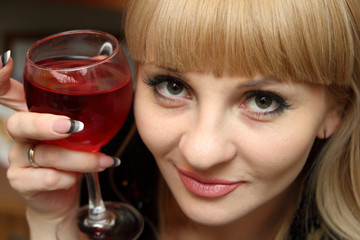 Young woman with bocal of red wine.