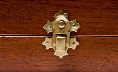 The lock of a wooden casket close up