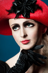 Retro style fashion portrait of a young woman in red hat