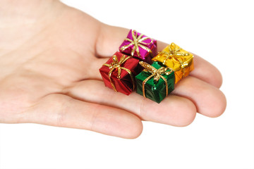 closeup of human hand holding little gifts, isolated