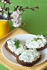 Cheese snack on rye bread and a bouquet