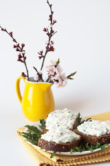 Cheese snack on rye bread and a bouquet
