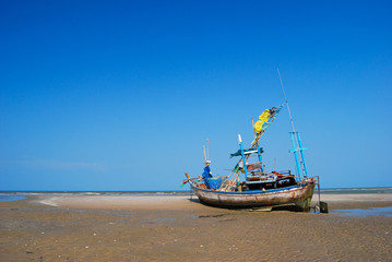 Naklejka na ściany i meble fisherman boat on the sea shore