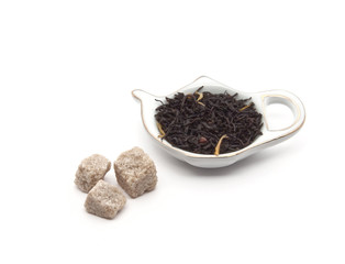 china saucer for tea bags with tea leaves and sugar