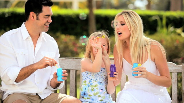 Multi-Ethnic Family Fun Blowing Soap Bubbles