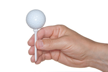 A golf ball on tee in hand isolated on white.