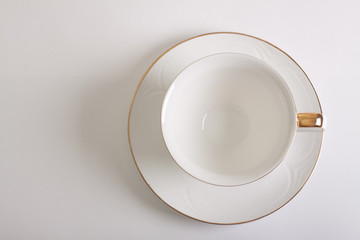 white empty cup and saucer top view