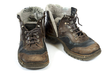 Old battered boots isolated on white background