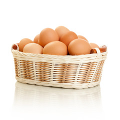 Eggs in basket isolated on white